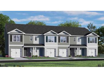 Attractive two-story townhome with a double garage and landscaped front yard at 466 Belgian Red Way, Wake Forest, NC 27587