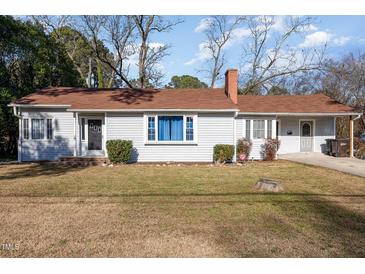 Charming ranch home with a brick chimney and well-maintained lawn at 107 Justice St, Louisburg, NC 27549