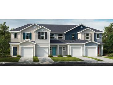 Row of townhouses with teal, blue, and gray siding and attached garages at 1111 Mountain Crown St, Durham, NC 27703