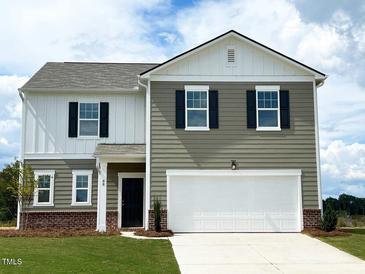 Charming two-story home with gray siding, white trim, and attached two-car garage at 115 N Keatts Winner Ct, Clayton, NC 27520