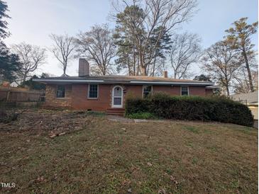 Charming brick home with a sloping front lawn and mature trees at 2705 Royster St, Raleigh, NC 27608