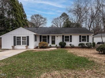 Charming ranch home with white siding, landscaping, and a spacious yard at 505 Harvard St, Raleigh, NC 27609