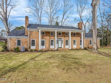 Brick house with columns, large windows, and a spacious lawn at 191 Pine Lake Dr, Siler City, NC 27344