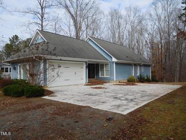 Ranch style home with attached garage and large driveway at 513 Port Dr, Henderson, NC 27537