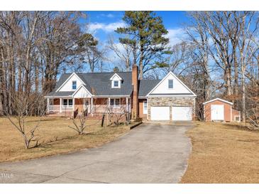 Brick ranch house with attached garage and shed at 101 Creekside Dr, Selma, NC 27576