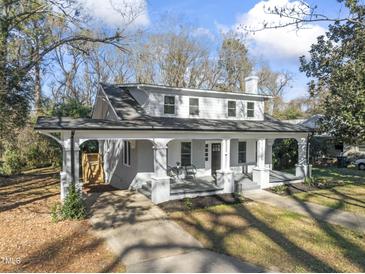 Charming two-story house with a wrap-around porch and landscaped yard at 123 E Weatherspoon St, Sanford, NC 27330