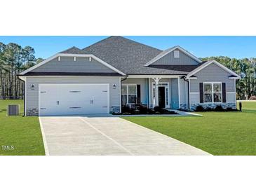 Gray house with white garage door and landscaping at 534 Glenkirk Pl # 110, Garner, NC 27529