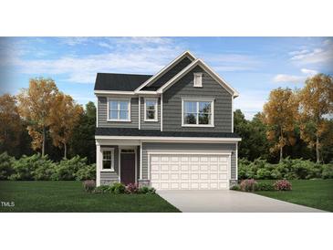 Two-story house with gray siding, white garage door, and landscaping at 1161 Atterlee Ln # 91, Graham, NC 27253