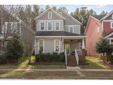 Two-story gray house with brick steps, landscaping, and a front porch at 591 Millbrook Dr, Pittsboro, NC 27312