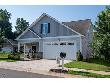 Gray two-story house with white garage door and landscaping at 701 Cherry Tree Dr, Mebane, NC 27302