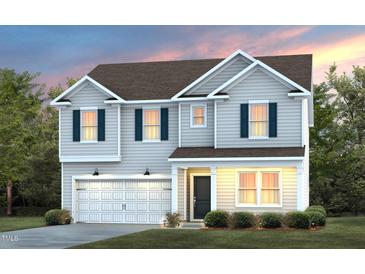 Two-story house with gray siding, white garage door, and landscaping at 2503 Seacoast Ave, Durham, NC 27703