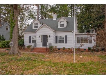 Charming white house with a gray roof and manicured lawn at 421 S Morgan St, Roxboro, NC 27573
