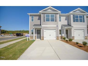 Two-story townhome with gray siding, two-car garage, and landscaping at 507 Fife Ct, Gibsonville, NC 27249