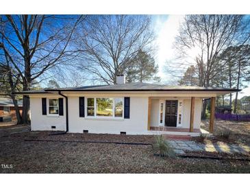 Updated ranch home features a charming front porch and brick facade at 603 Forest Dr, Garner, NC 27529