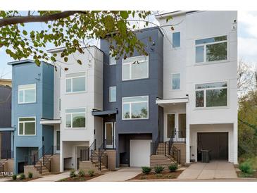 Modern three-story townhomes with attached garages and staircases at 612 Rocky Knob Ct, Raleigh, NC 27601