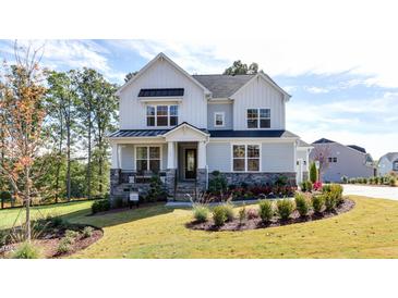 Two-story home with gray siding, white accents, and landscaped lawn at 905 Jasper Mine Trl # 739 Edison, Raleigh, NC 27610