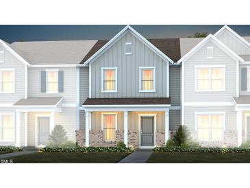 Two-story townhome with gray siding, brick accents, and landscaping at 393 Fosterton Cottage Way, Raleigh, NC 27603