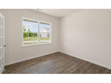 Bright home office features wood-look floors and a large window at 1129 Middlecrest Dr, Rocky Mount, NC 27804
