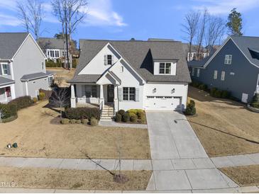 Stunning two-story home with a white exterior, gray roof, and attached garage at 2317 Glade Mill Ct, Fuquay Varina, NC 27526