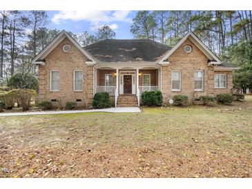 Brick house with front porch and landscaped yard at 4701 Regalwood Dr, Raleigh, NC 27613