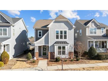 Gray two-story house with brick accents and a green door at 6604 Truxton Ln, Raleigh, NC 27616