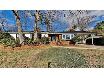 Charming ranch home with brick facade and well-maintained lawn at 1921 Port Royal Rd, Raleigh, NC 27609