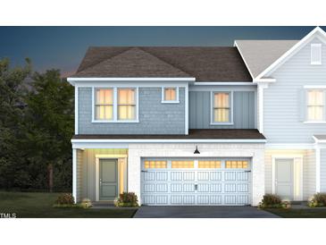 Two-story townhome with gray siding, white trim, and a two-car garage at 295 Broomside Ave, Raleigh, NC 27603
