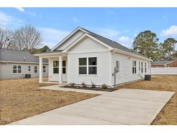 Charming craftsman style home with a covered porch and landscaped yard at 206 3Rd St, Erwin, NC 28339