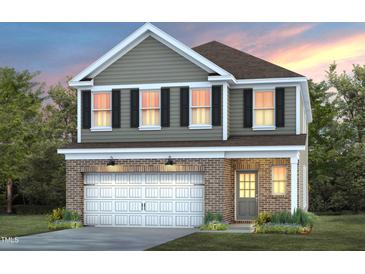 Two-story house with brick and siding exterior, two-car garage, and landscaping at 518 Donnegal Farm Dr, Fuquay Varina, NC 27526