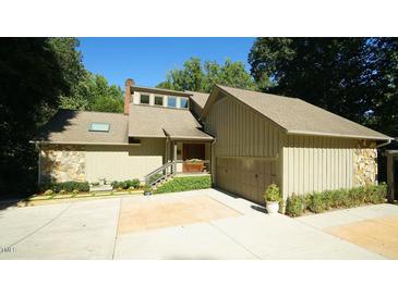 Two-story home with attached garage and landscaped yard at 2213 Weybridge Dr, Raleigh, NC 27615