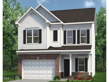 Two-story home with brick and shingle exterior, two-car garage, and landscaping at 33 W Victory View Ter, Smithfield, NC 27577