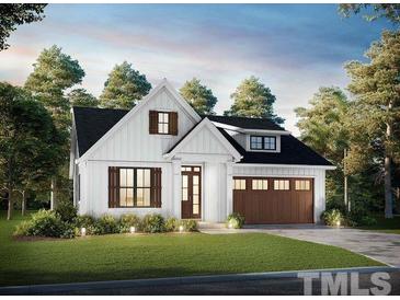 Charming farmhouse exterior with a brown garage door at 13301 Nc 27 Hwy # 3, Broadway, NC 27505
