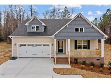 New construction home with gray and beige siding, two car garage, and front porch at 181 Andrews Landing Dr, Wendell, NC 27591