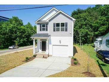 Two-story house with gray siding, white trim, and a two-car garage at 804 N Magnolia Ave, Dunn, NC 28334