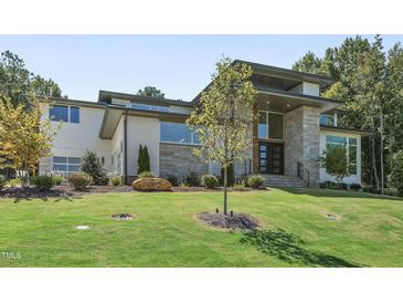 Modern two-story home with stone and white siding at 213 Westhampton Dr, Pittsboro, NC 27312