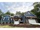 Blue house exterior with stone accents and a white garage door at 1350 Geneva Albright Rd, Graham, NC 27253