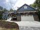 Blue house exterior with stone accents and a white garage door at 1350 Geneva Albright Rd, Graham, NC 27253