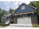 Blue house with white garage and stone accents at 1350 Geneva Albright Rd, Graham, NC 27253