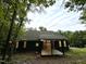 Dark green house back with deck and wooded area in background at 1350 Geneva Albright Rd, Graham, NC 27253