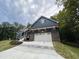 Blue house exterior with stone accents and a white garage door at 1350 Geneva Albright Rd, Graham, NC 27253