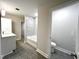 Main bathroom with a bathtub, toilet and modern vanity at 1350 Geneva Albright Rd, Graham, NC 27253