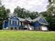 Blue house exterior with stone accents and a white garage door at 1350 Geneva Albright Rd, Graham, NC 27253