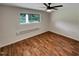 Bright bedroom featuring wood-look flooring and a large window at 130 S Estes Dr # B7, Chapel Hill, NC 27514