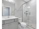 Modern bathroom with gray vanity, white toilet, and large glass shower at 124 Crested Coral Dr, Holly Springs, NC 27540