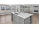 Modern kitchen island with white quartz countertop at 124 Crested Coral Dr, Holly Springs, NC 27540