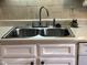 Clean stainless steel double sink with modern faucet at 1375 Garden Crest Cir, Raleigh, NC 27609