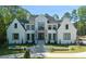 Impressive white two-story house with landscaping and a large driveway at 6509 Century Oak Court, Raleigh, NC 27613