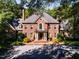 Brick house with a large porch and columns, showcasing its classic architecture at 2441 W Lake Dr, Raleigh, NC 27609