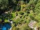 Aerial showcasing a home with extensive gardens and a greenhouse at 2441 W Lake Dr, Raleigh, NC 27609