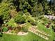 Stunning aerial view of a home with beautifully landscaped gardens at 2441 W Lake Dr, Raleigh, NC 27609